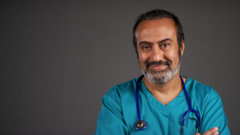 Middle-Aged-Doctor-Folding-Arms-and-Smiling-Portrait